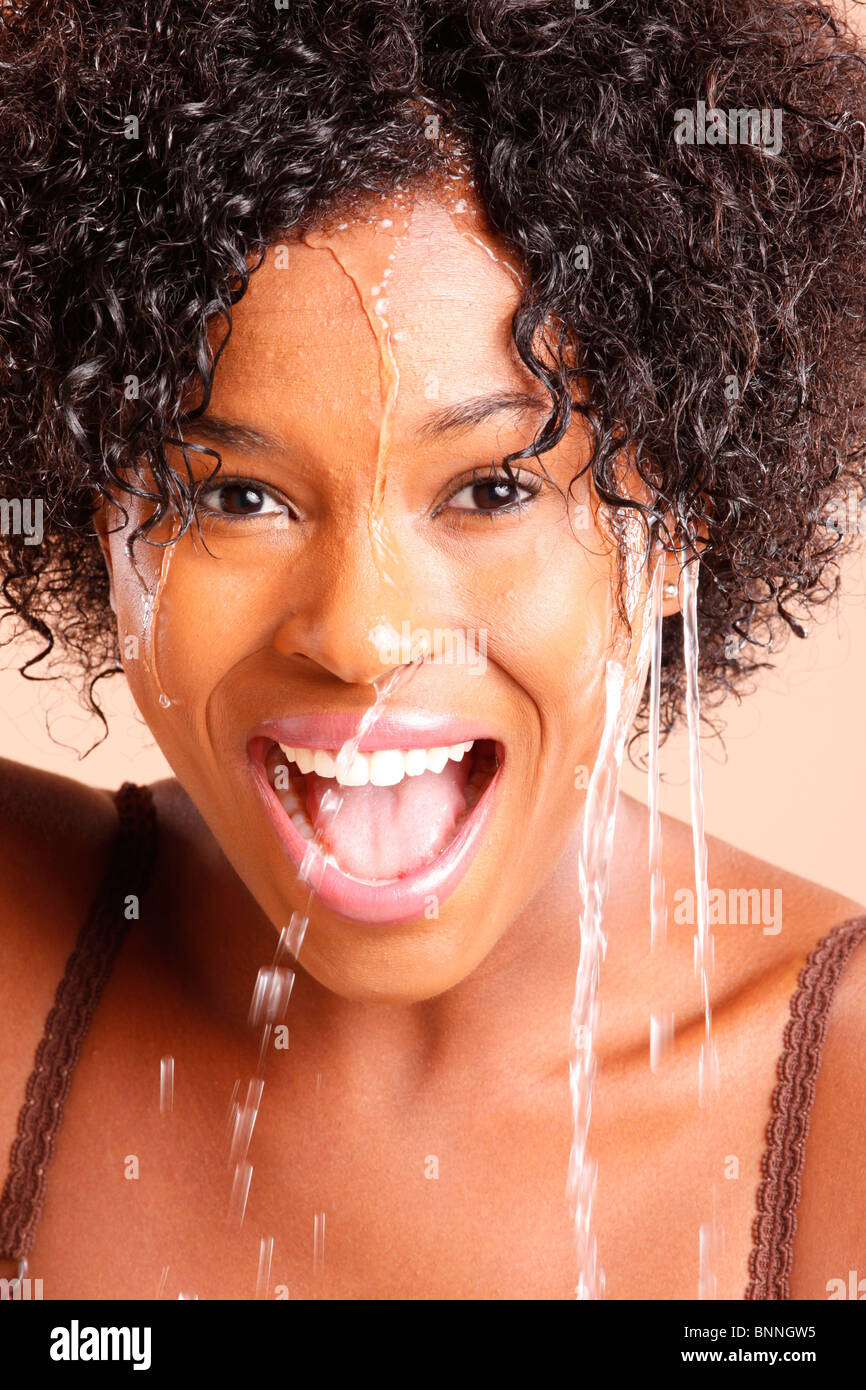 Cute African American with water dripping through her face Stock Photo