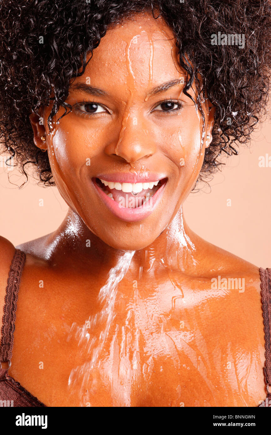 Cute African American with water dripping through her face Stock Photo