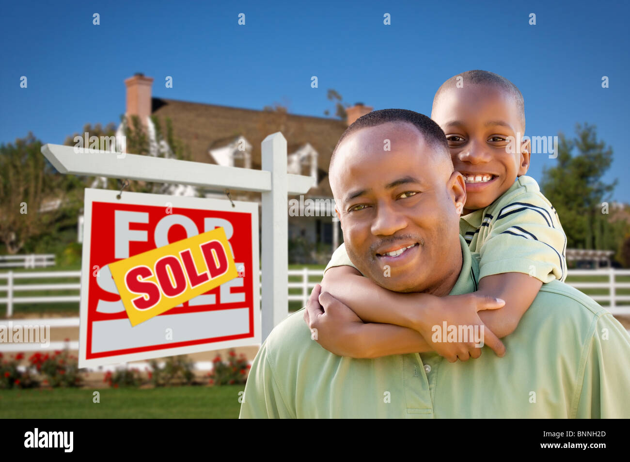 Happy African American Father and Son in Front of New Home and Sold ...