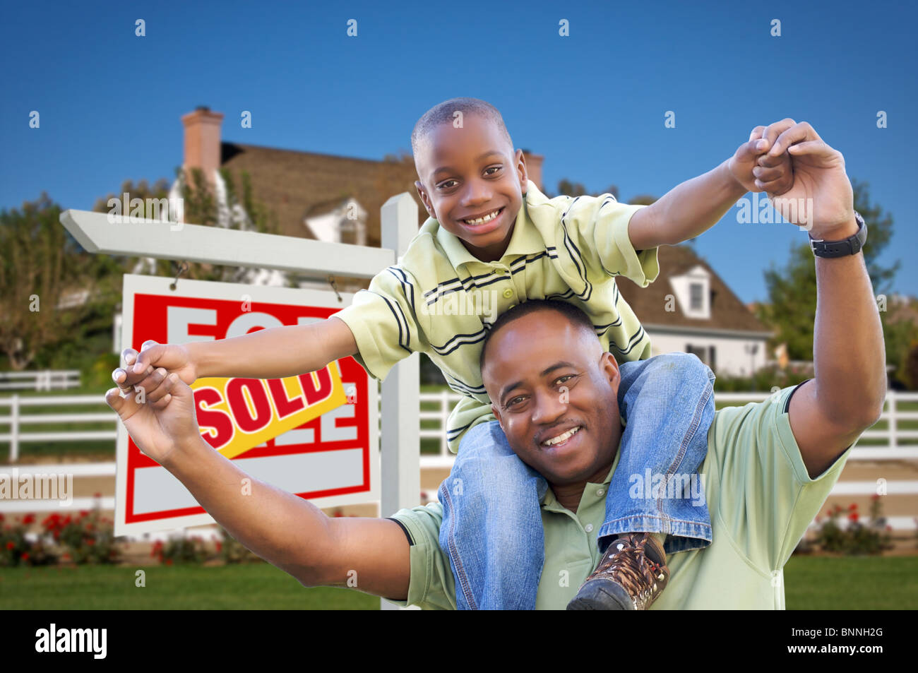 Happy African American Father and Son in Front of New Home and Sold ...