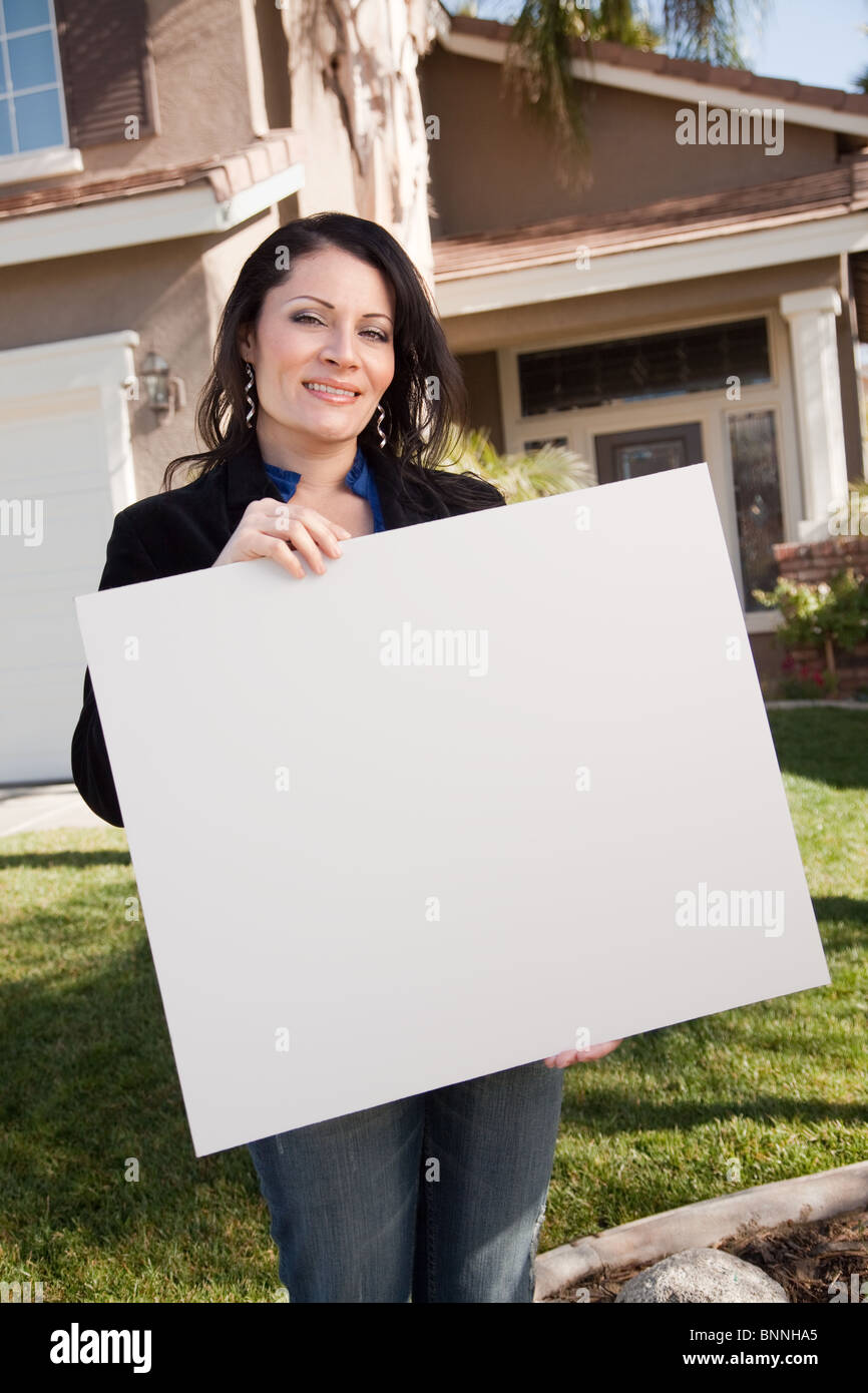 Happy Attractive Hispanic Woman Holding Blank Sign in Front of House ...