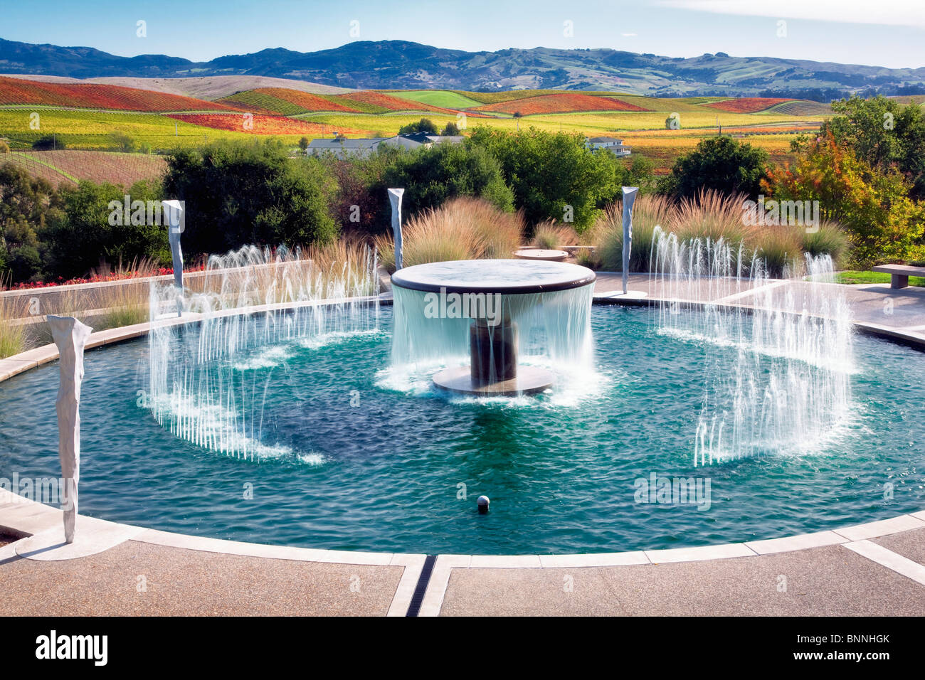 Fountain at Artesia Winery with fall colored vineyards. Napa Valley, California. Stock Photo