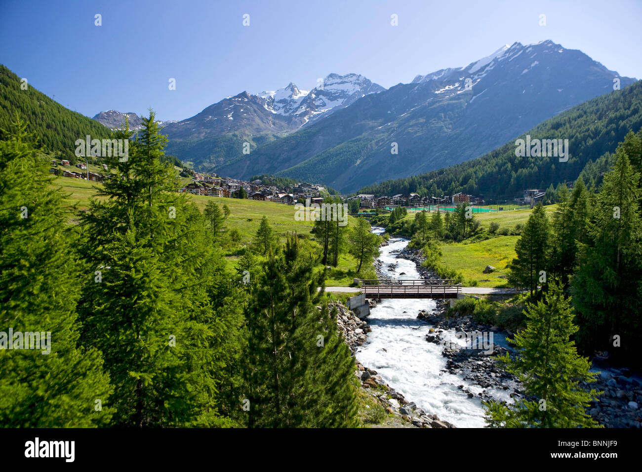 Switzerland swiss scenery Saas Fee valley of Saas Saastal canton Valais mountains nature wood forest trees river flow Saaser Stock Photo