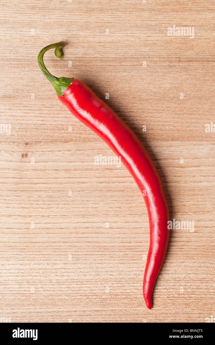 red chili pepper on wooden table Stock Photo - Alamy