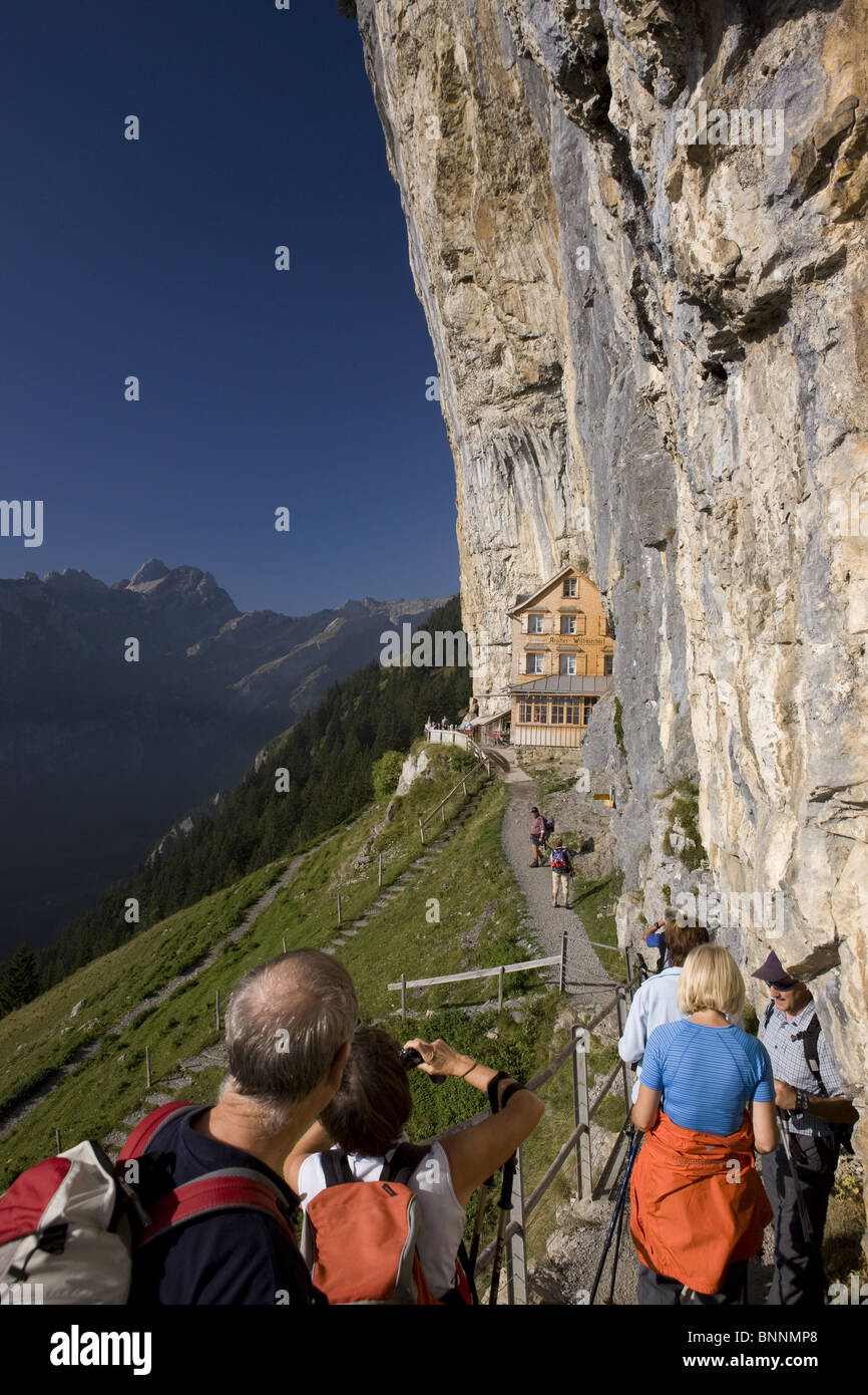 Switzerland swiss inn Aescher Alpstein tourist walk hike group footpath precipitously persons Ebenalp mountains catering trade Stock Photo