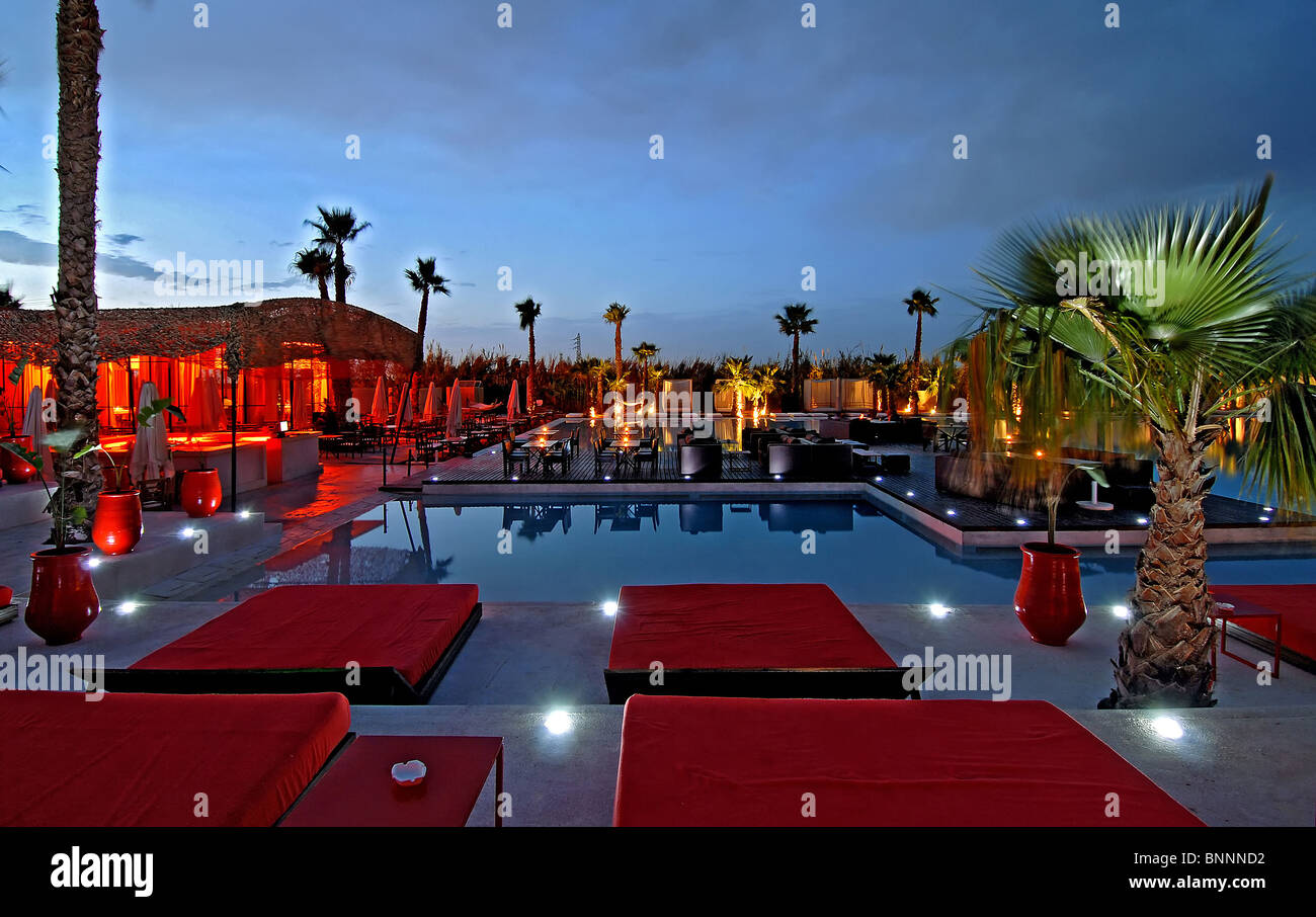 Morocco Marrakech North Africa La plague nuisance blusher club couches lying beds Chill out pool evening Stock Photo