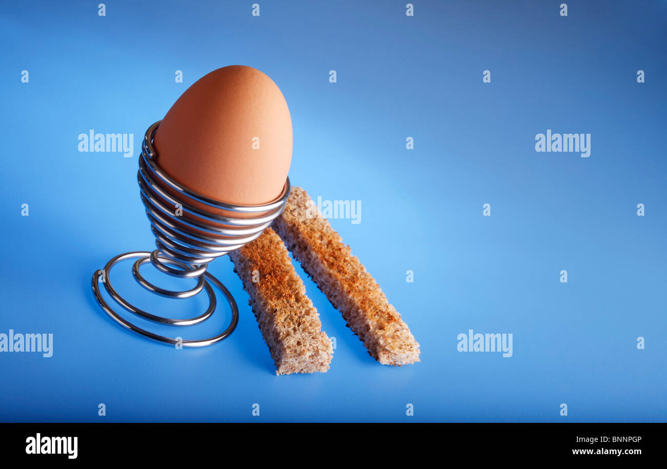 Boiled egg and soldiers on blue Stock Photo Alamy