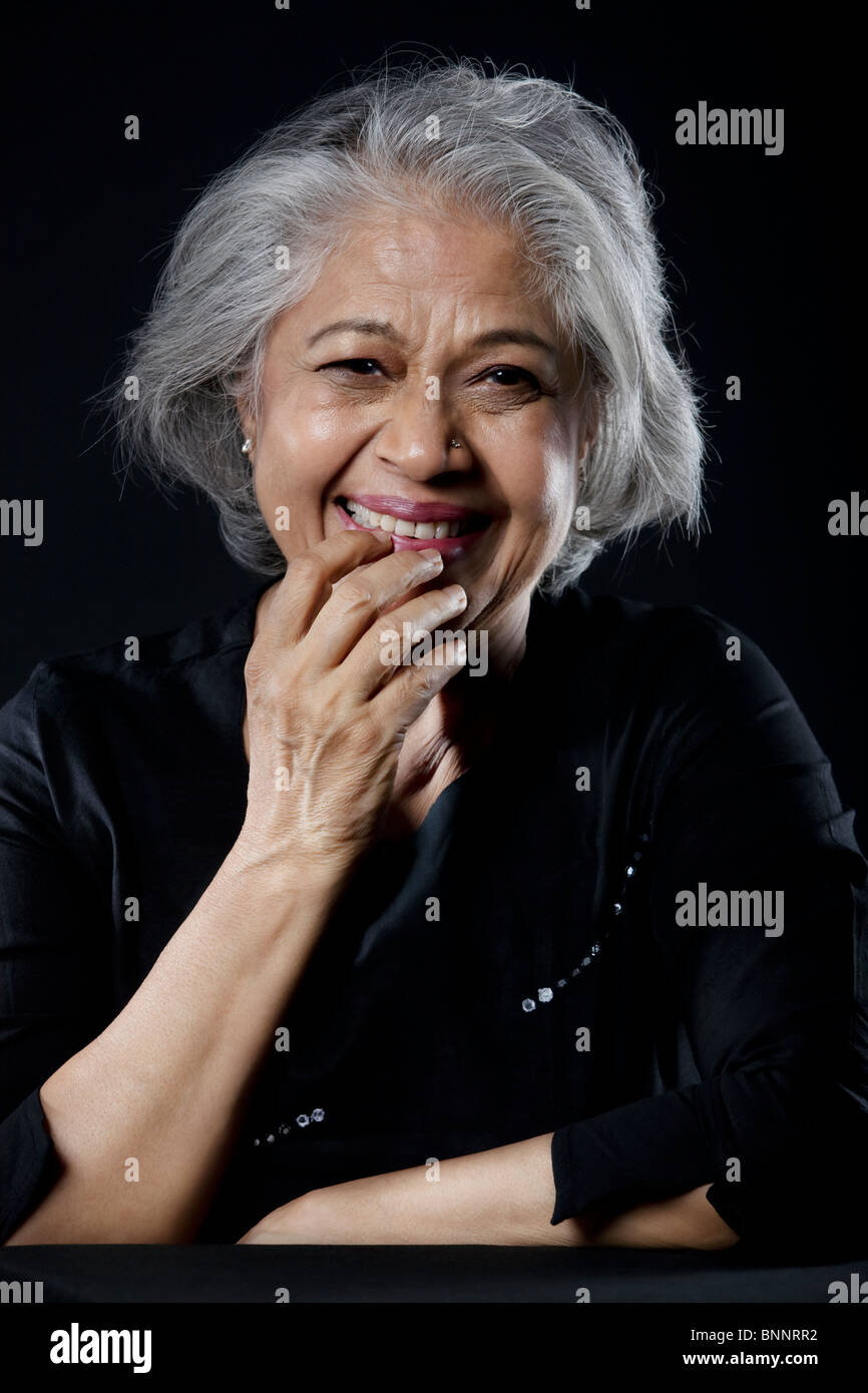 Old woman chuckling Stock Photo