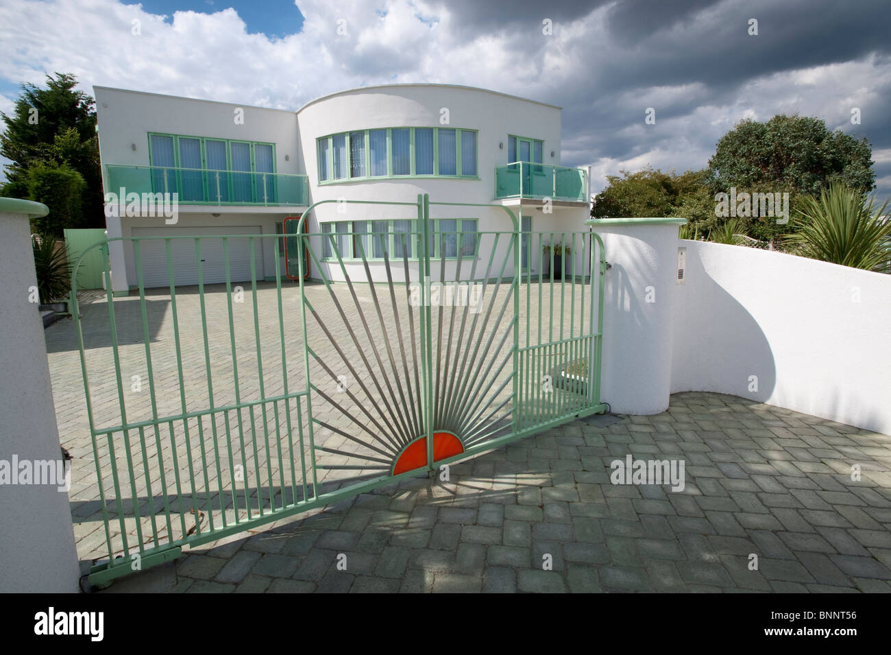 Art deco house with curved white walls and distinctive sunrise railings