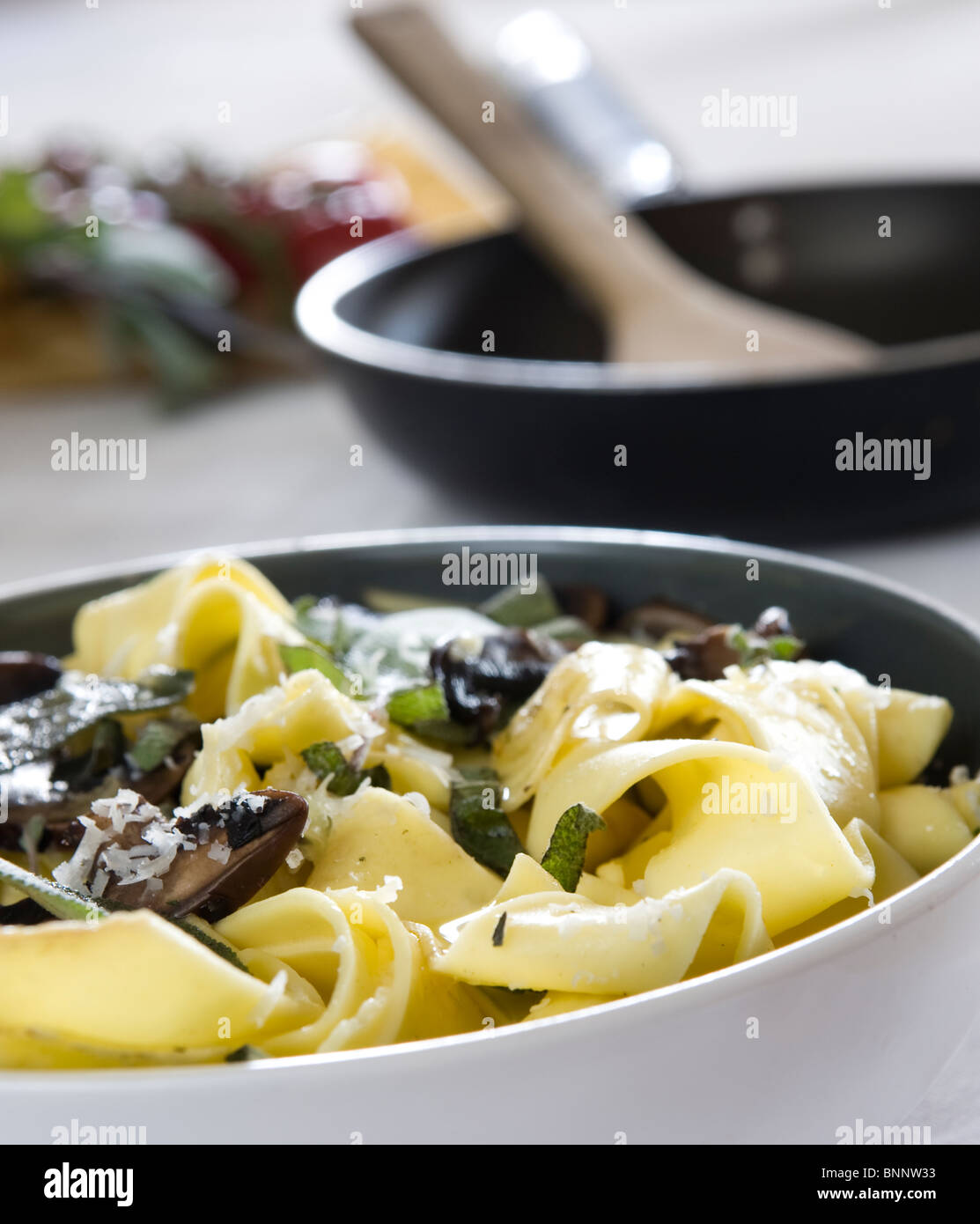 Fresh tagliatelle with sage, mushrooms and parmesan Stock Photo