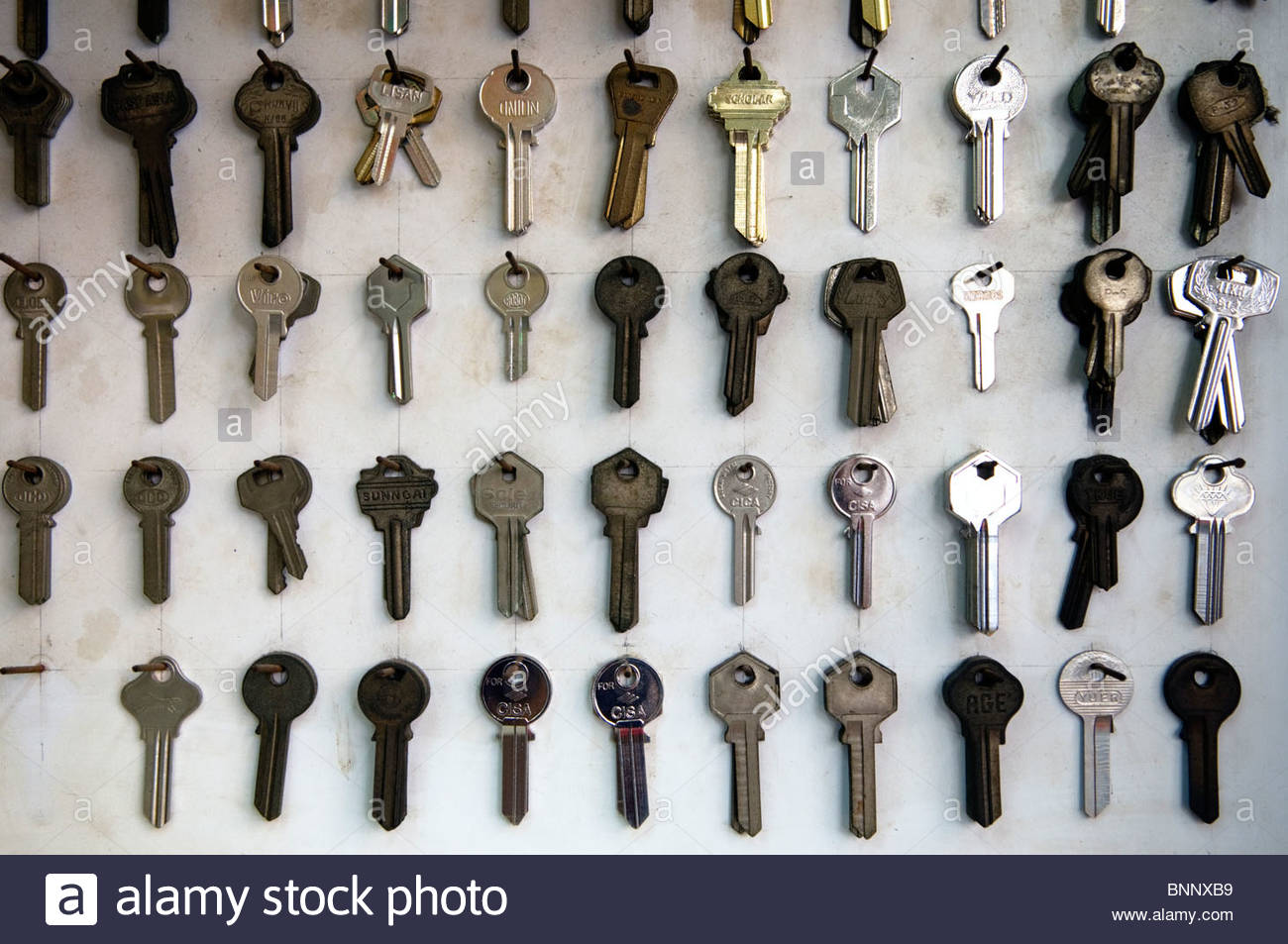 keys hanging on nails in a key shop in hong kong stock photo