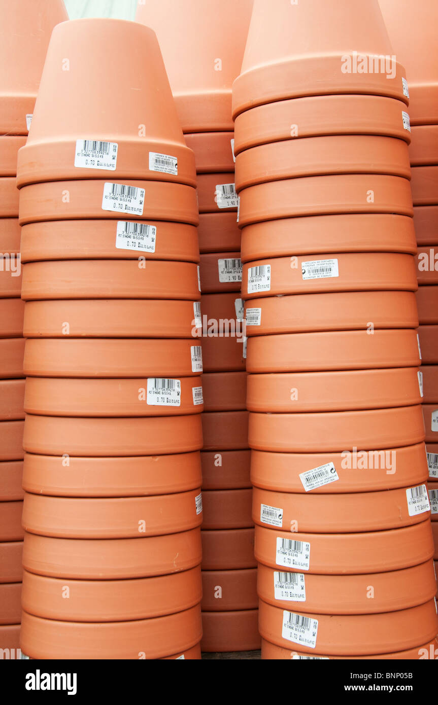 Stacked terracotta flower pots for sale at a garden centre Stock Photo