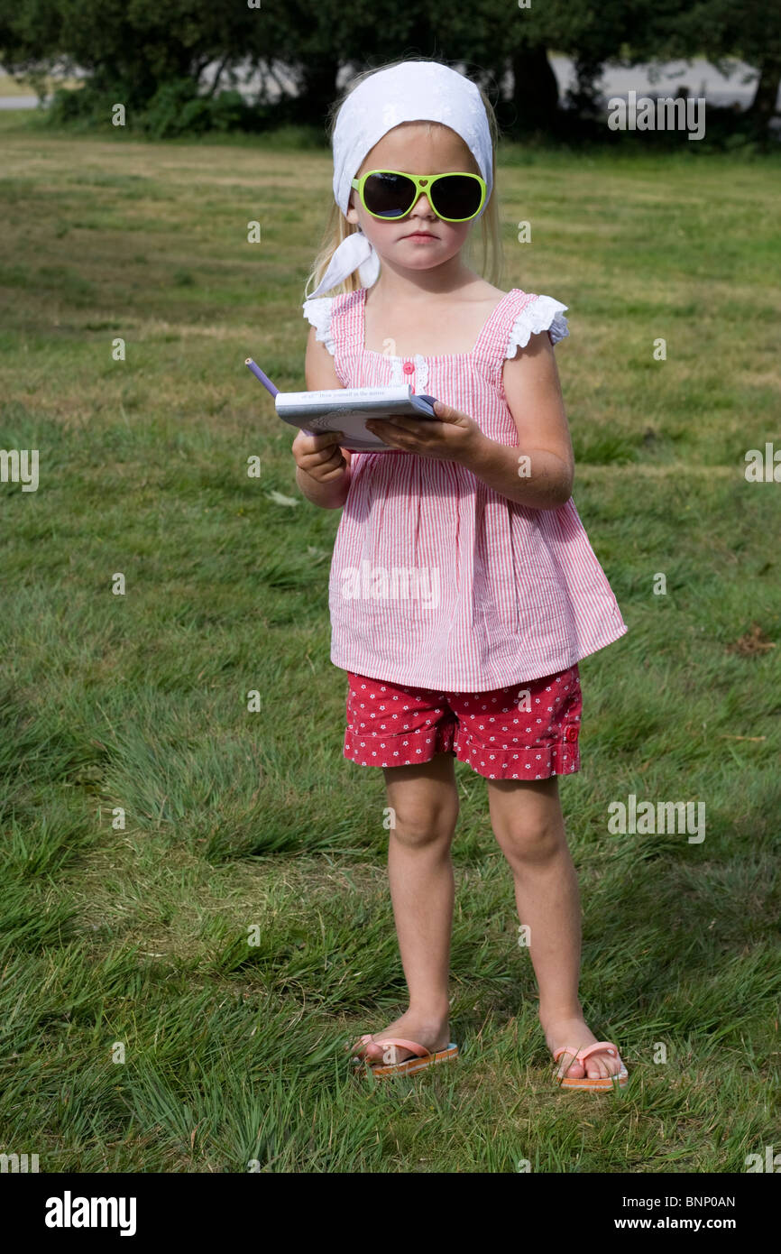 a young girl with note pad and pen Stock Photo