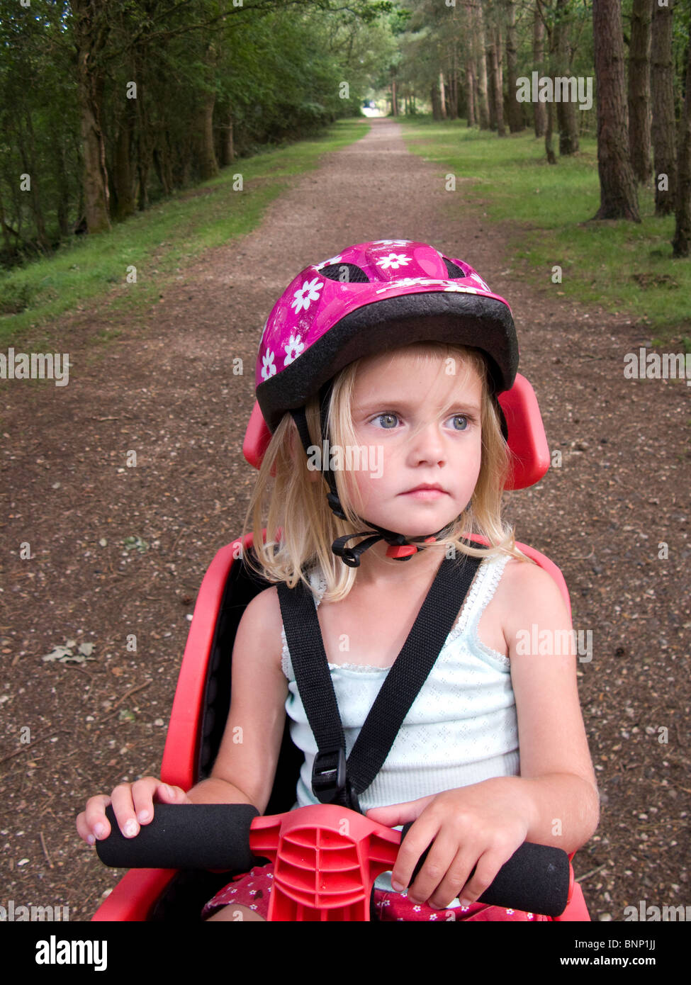 Young girl in a bicycle child seat on cycle track Stock Photo Alamy