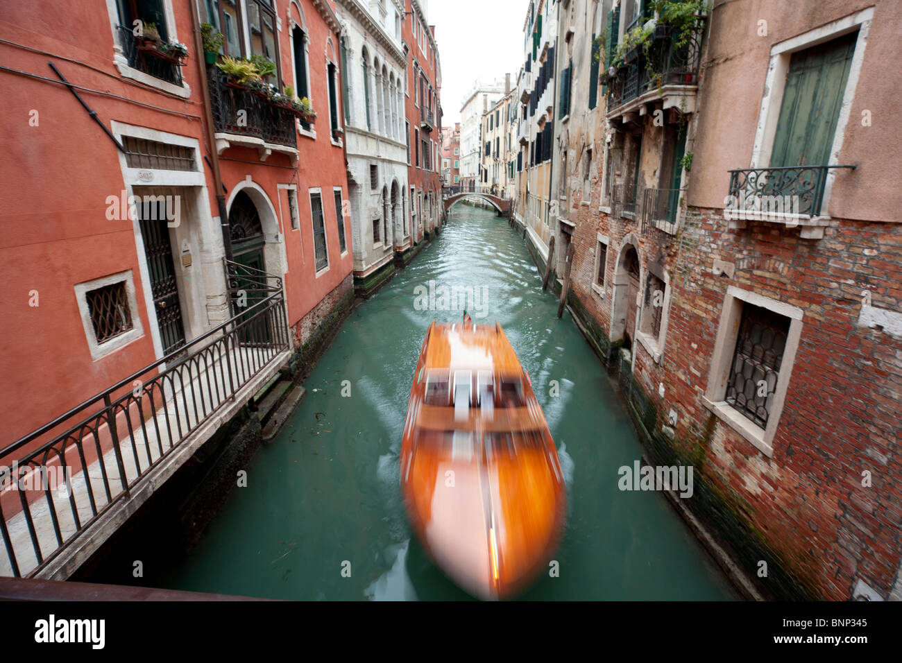 Venetian Canal with orange Speedboat Stock Photo
