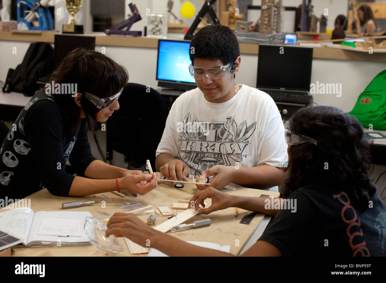Hispanic students work on model solar car bodies in engineering class at Manor New Tech High School in Manor, Texas. Stock Photo