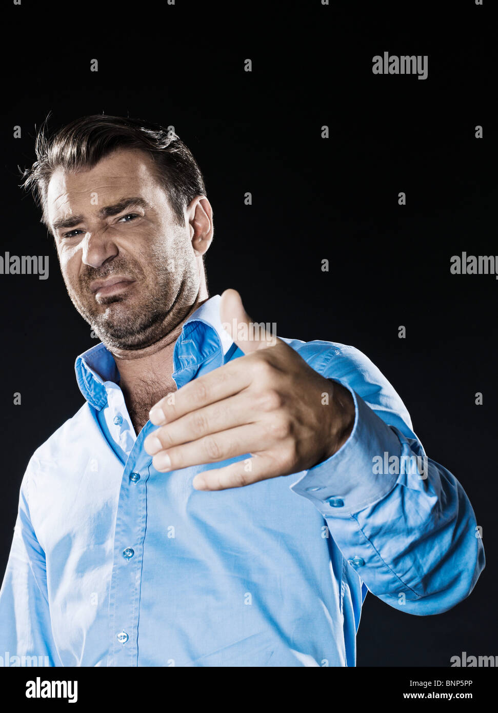 caucasian man unshaven reject unpleasant smell portrait isolated studio on black background Stock Photo
