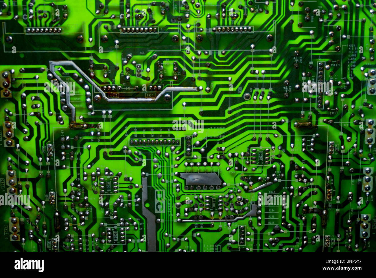 A glowing green computer circuit board. Stock Photo