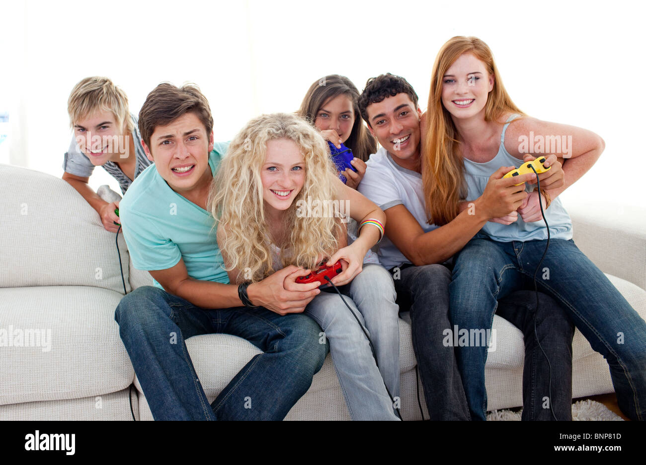 Teenagers playing video games at home Stock Photo - Alamy