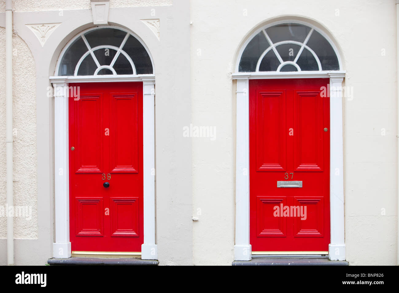 Red front door in a university building in Bangor, North Wales Stock