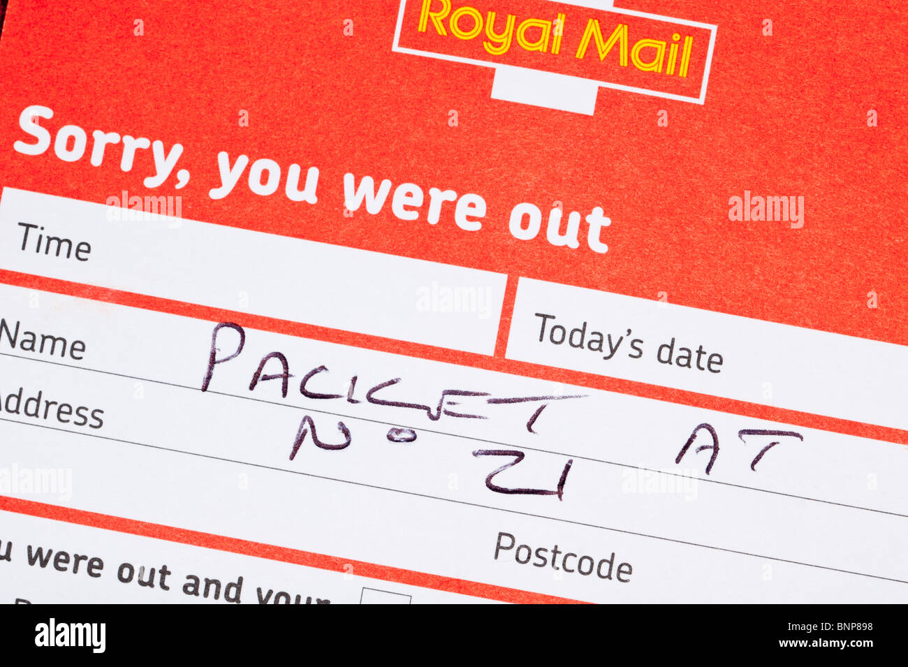 A Royal Mail form left when occupier was out stating that a parcel is left with neighbour in the Uk Stock Photo