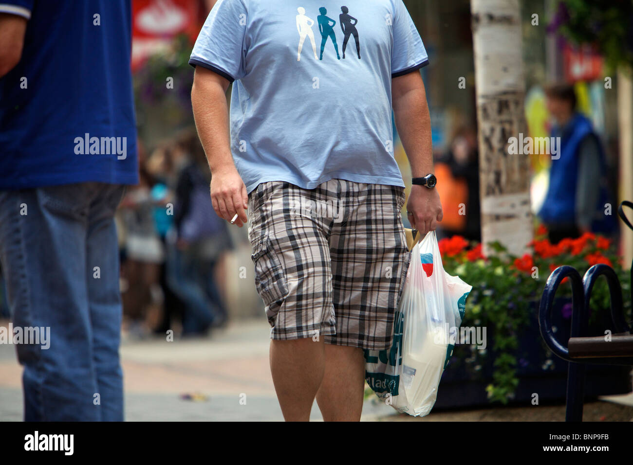 Overweight people on shopping street Stock Photo