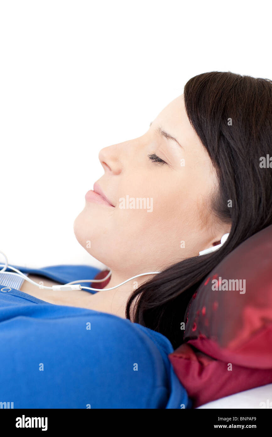 Happy teen girl listening music lying on a sofa Stock Photo - Alamy