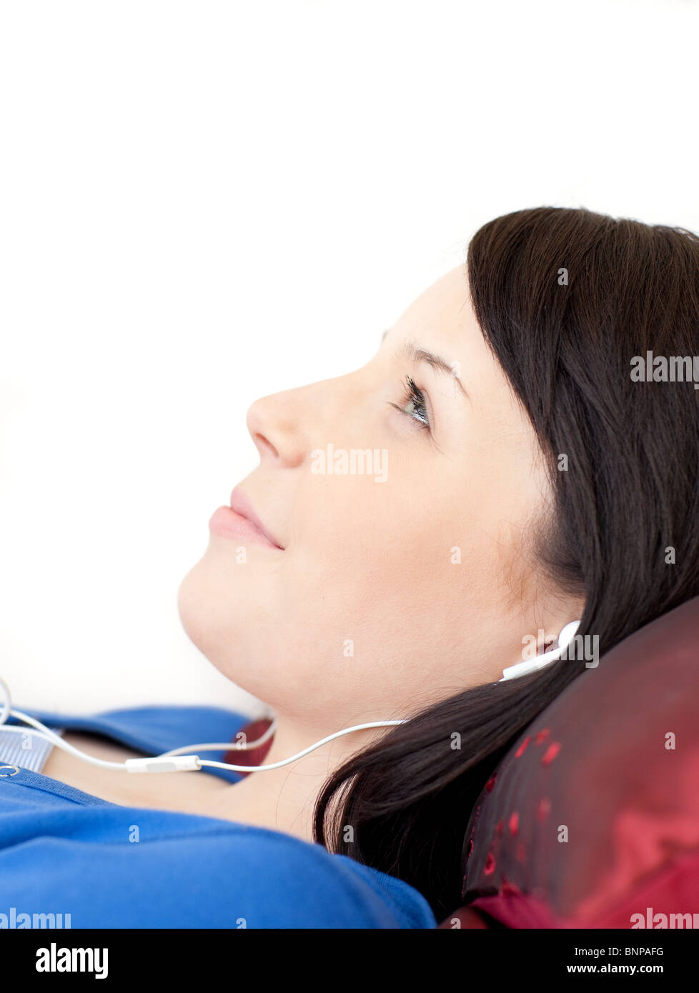 Charming teen girl listening music lying on a sofa Stock Photo - Alamy
