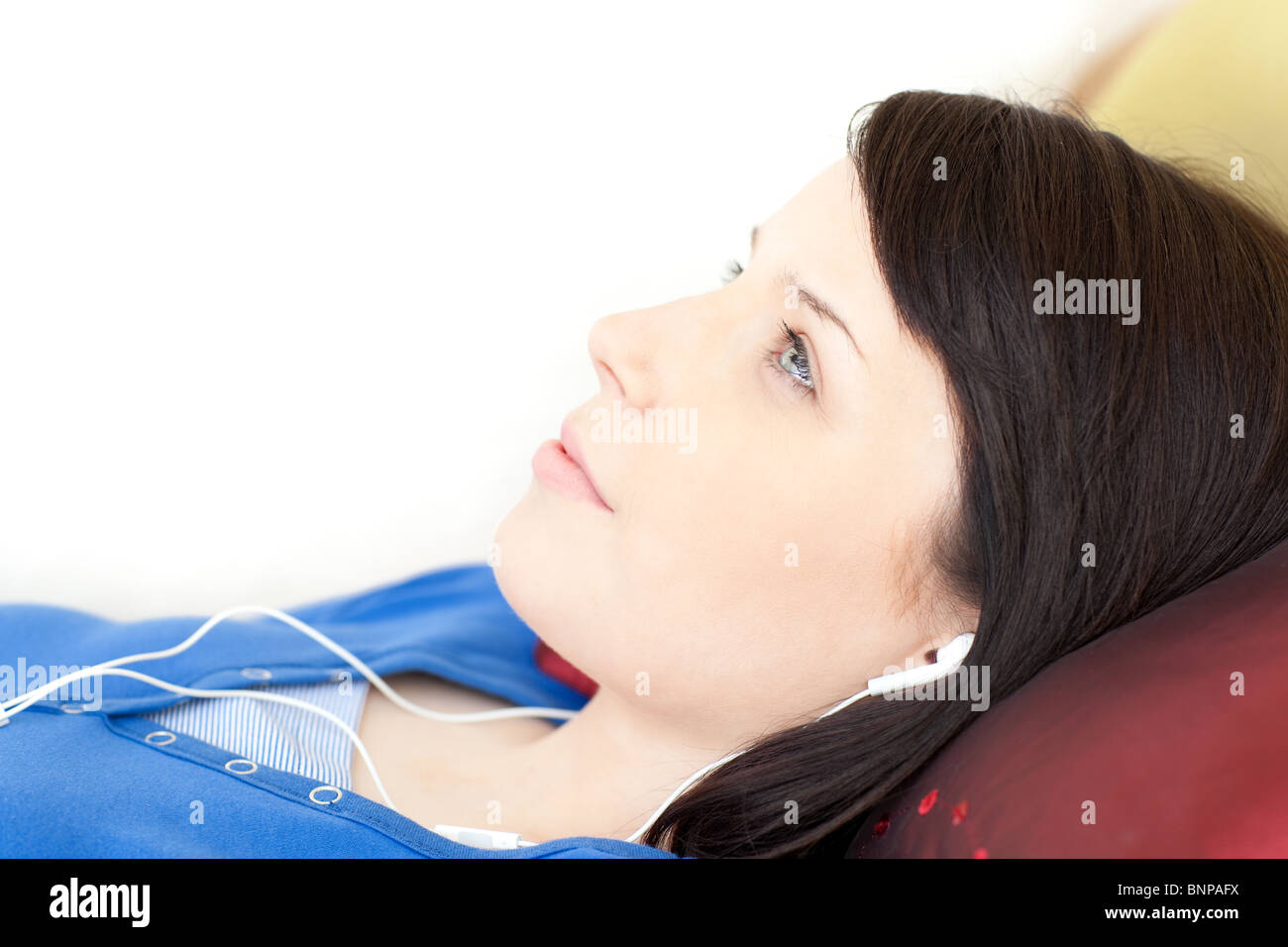 Pretty teen girl listening music lying on a sofa Stock Photo - Alamy
