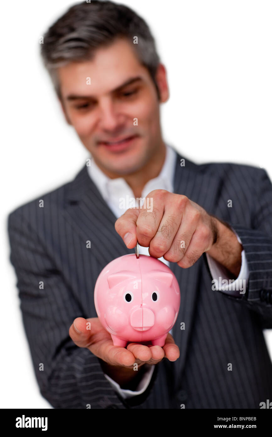 Charismatic male executive saving money in a piggybank Stock Photo Alamy