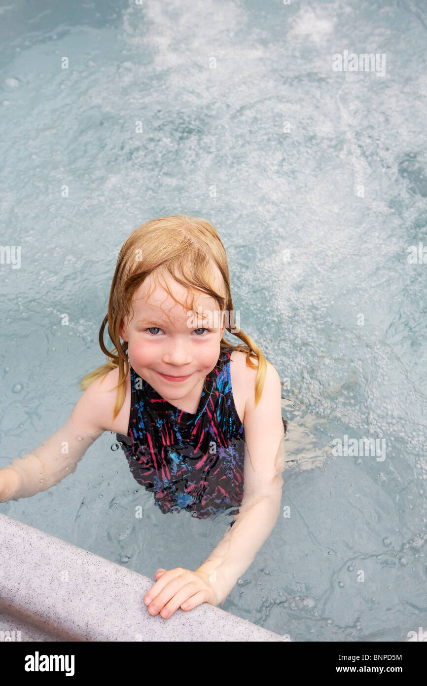 Young girl in a hot tub, looks at the camera Stock Photo