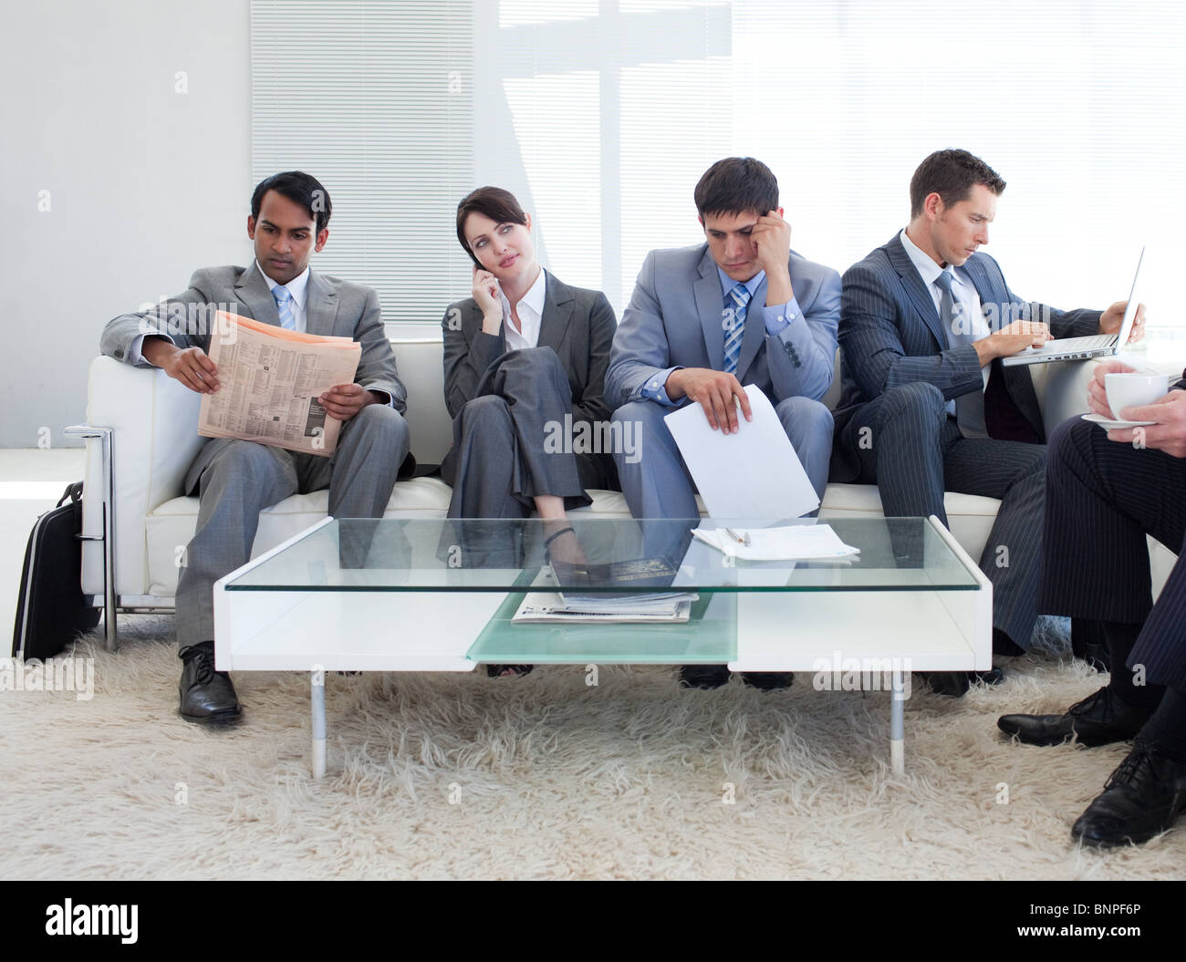 International business people sitting in a waiting room Stock Photo - Alamy