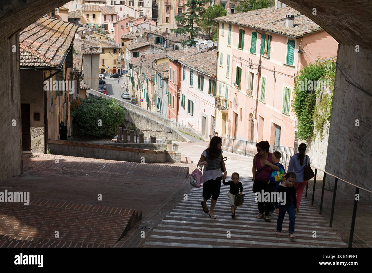 family group ascend steps near Via Apia in historical centre of Perugia Stock Photo