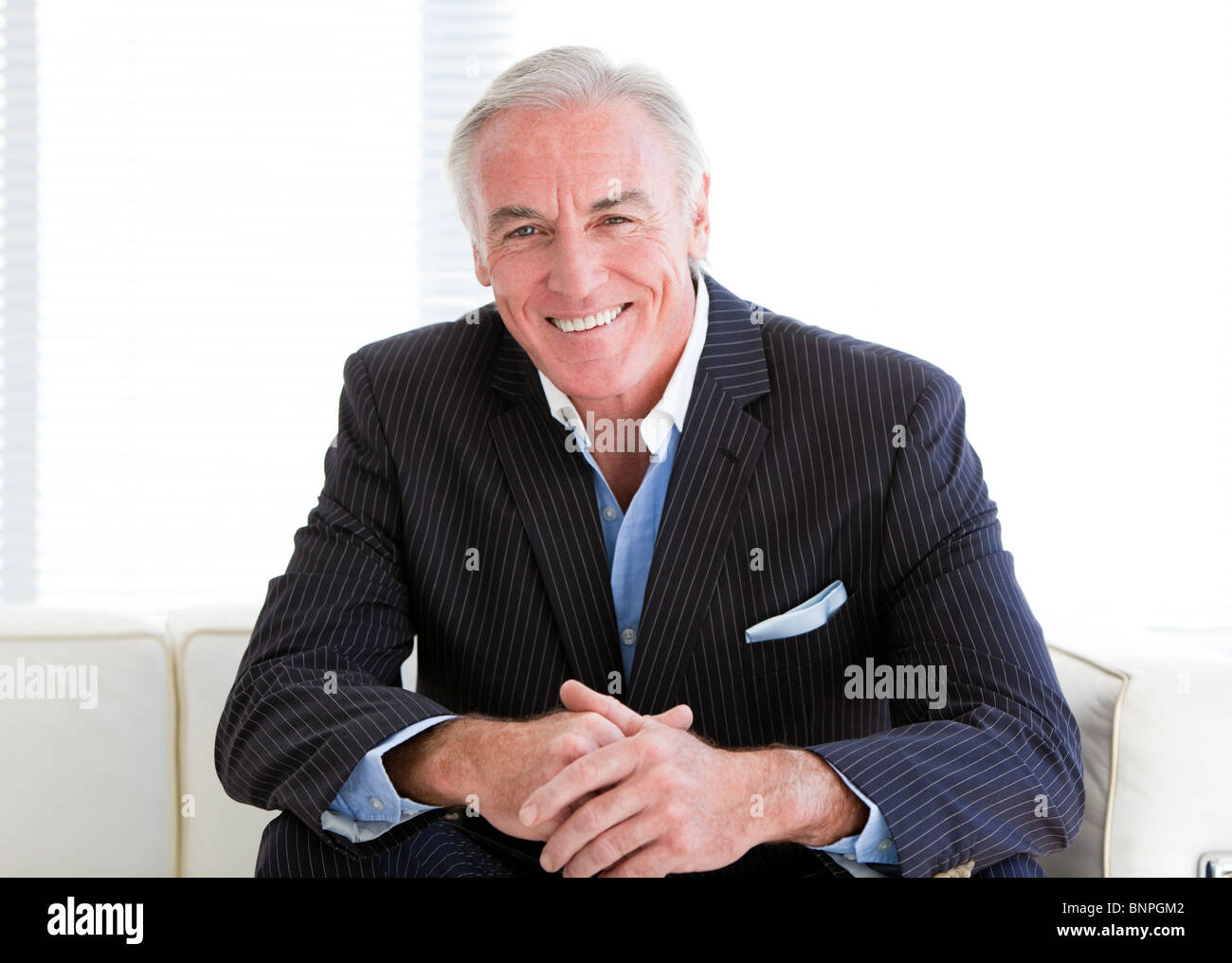 Happy senior man sitting sofa hi-res stock photography and images - Alamy