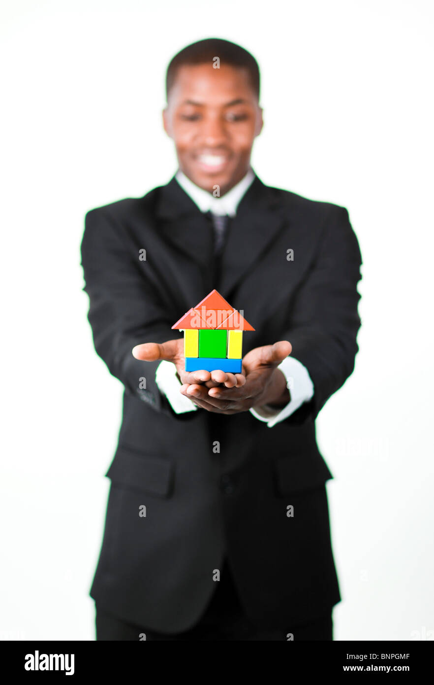 Friendly businessman holding a house in his hands Stock Photo - Alamy