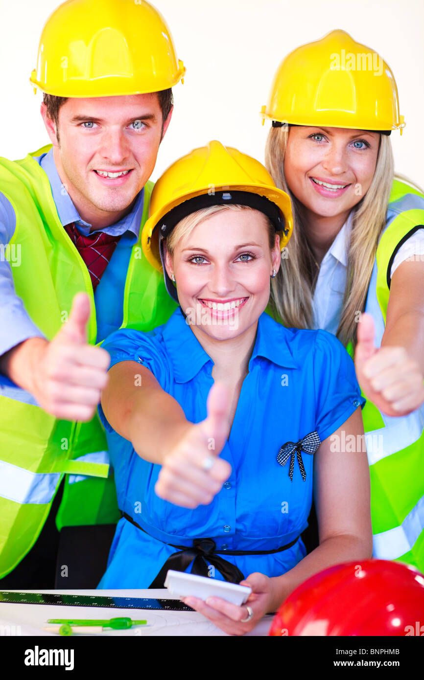 Team with hard hats looking at the camera Stock Photo - Alamy