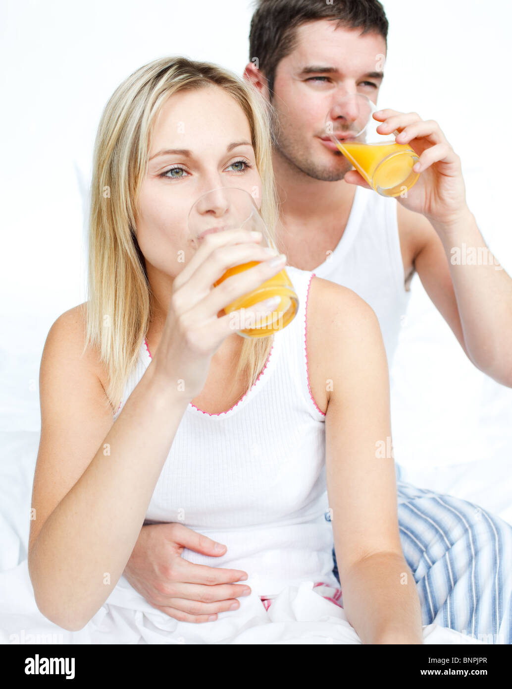 Couple drinking orange juice in bed Stock Photo - Alamy