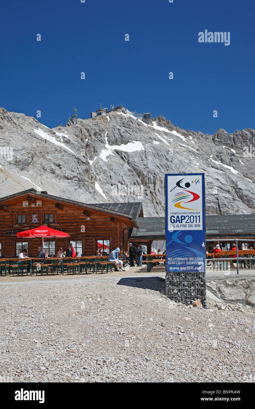 The Zugspitze Zugspitzplatt plateau with restaurants,  cogwheel and cable car station and view towards the summit Stock Photo