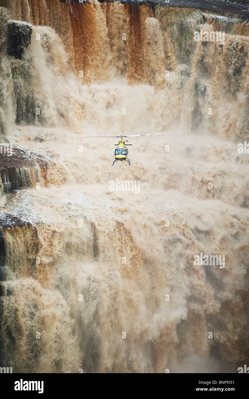 Tourists flying in helicopter exploring the Saikaka waterfall in Guyana South America Stock Photo