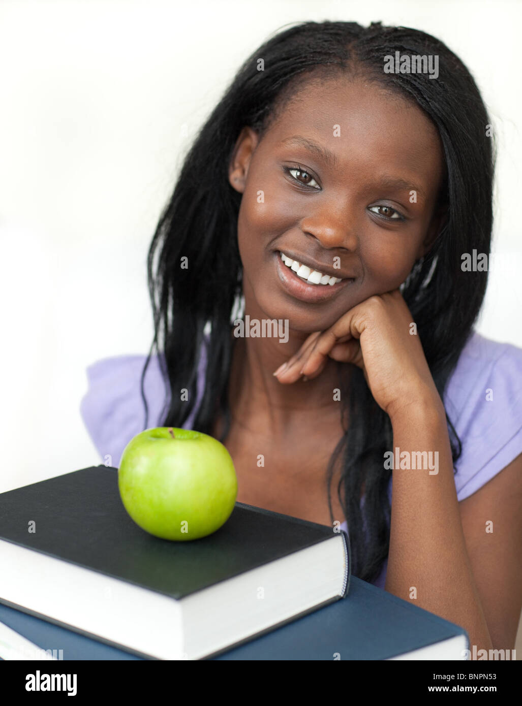 Cheerful student holding books smiling at the camera Stock Photo - Alamy
