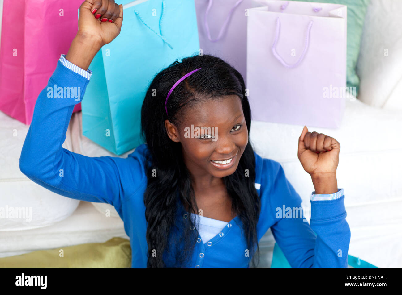 Joyful woman punching the air in celebration after shopping Stock Photo