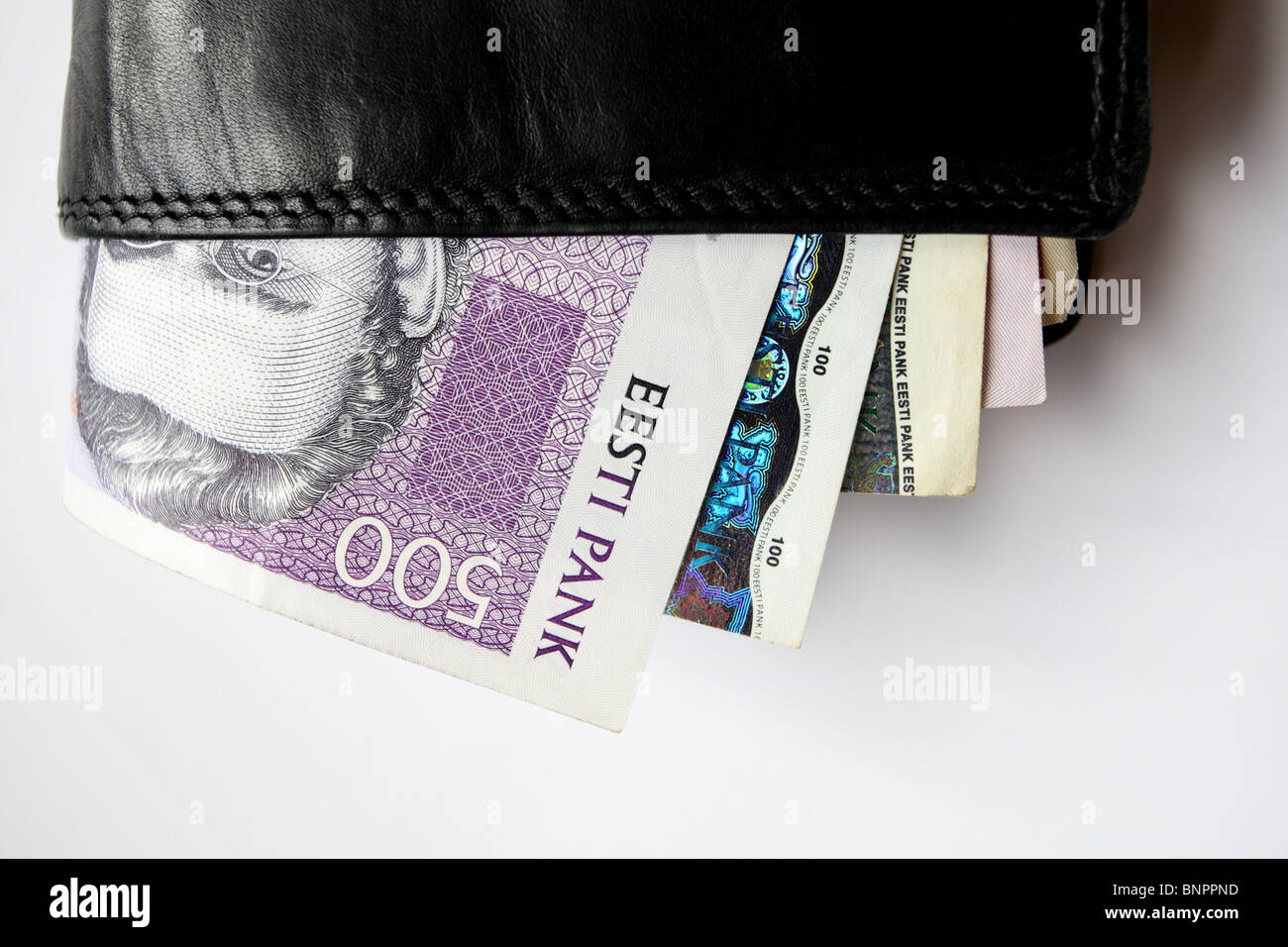 Black leather wallet and Estonian paper money sticking out. Stock Photo