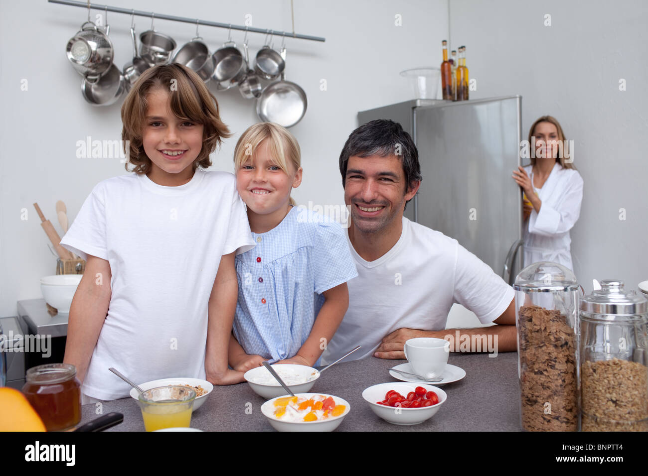 Smiling family having breakfast Stock Photo - Alamy