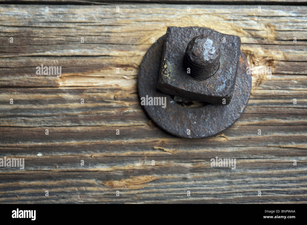Antique Rusty Bolt, Washer and Wood with Narrow DOF Stock Photo