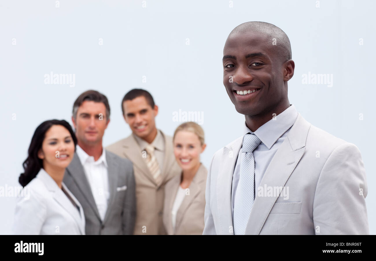 Smiling businessman in front of his team Stock Photo - Alamy