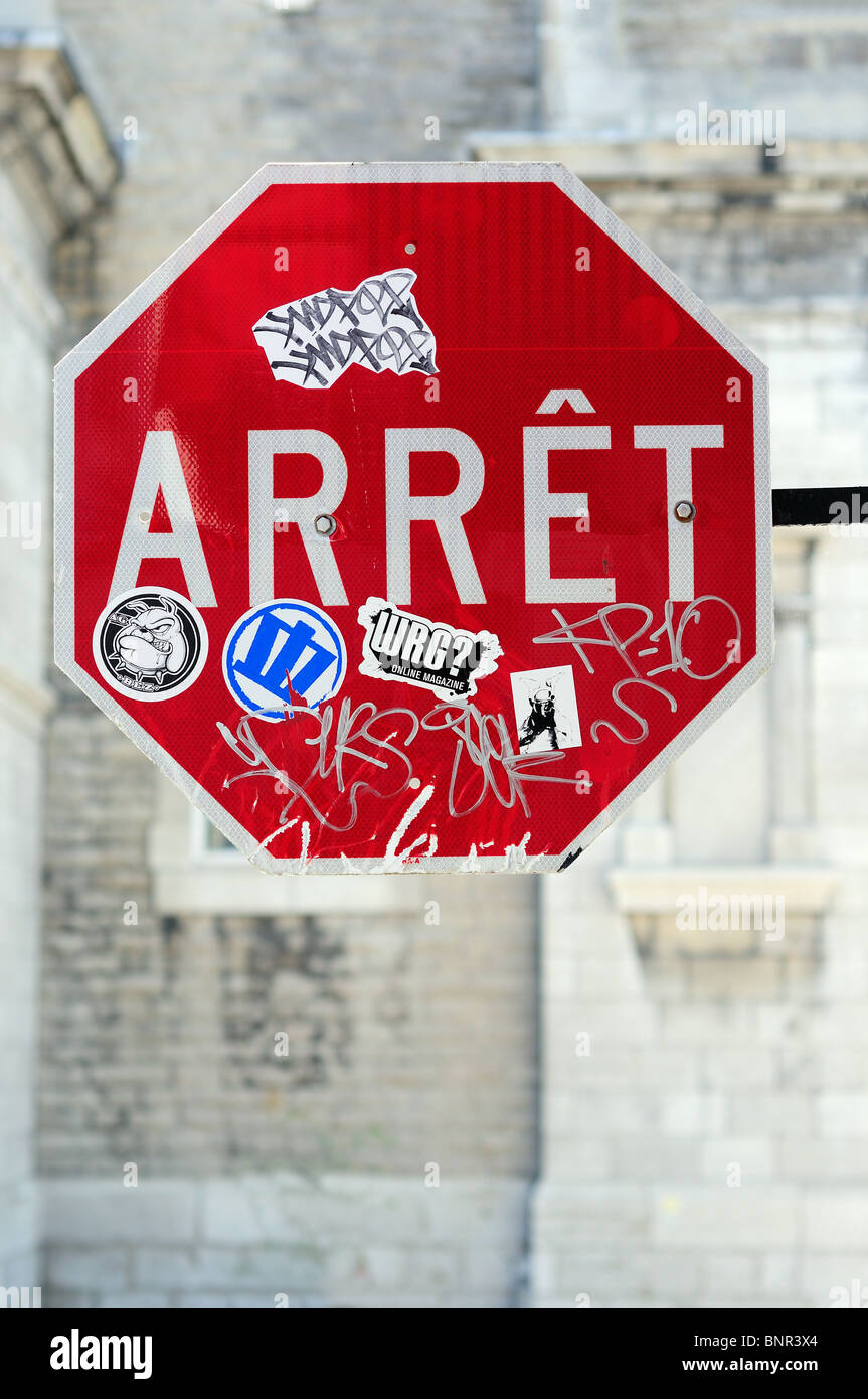 French Language Stop Sign, Arret Covered With Graffiti And Stickers