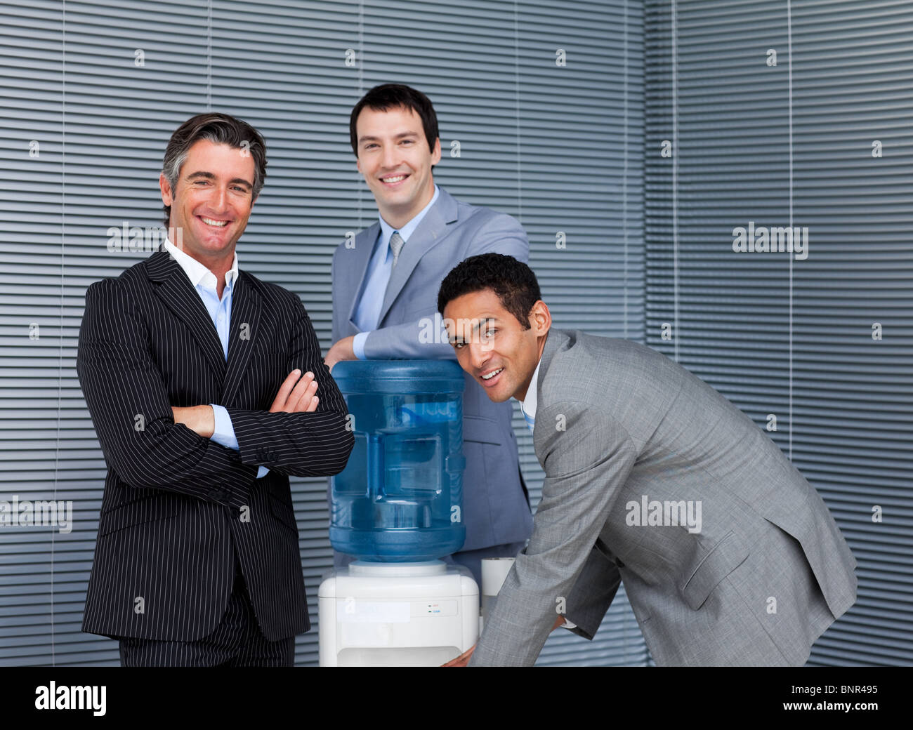 Business team at water cooler Stock Photo Alamy