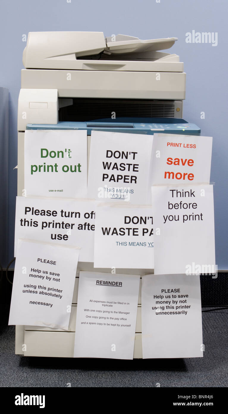 Intended as a (slightly!) humorous image of a printer/photocopier covered in unnecessary notices urging people not to waste paper etc Stock Photo