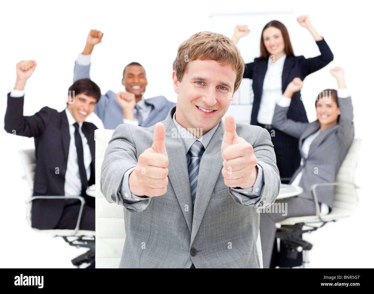 Happy manager with thumbs up in front of his team Stock Photo - Alamy