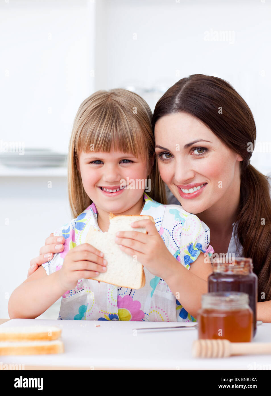Charming mother and her daughter having breakfast Stock Photo
